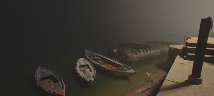 Boats resting on the Ganga in morning mist