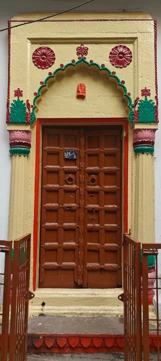 Painted doorway with a carved wooden door in the old city